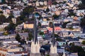 Rolling San Francisco hills with chuirch spire in the foreground and peaked roof homes and streets at golden hour Royalty Free Stock Photo