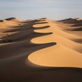 Rolling sand dunes with smooth, undulating shapes under a clear sky Royalty Free Stock Photo