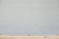 Rolling shutter door of large garage warehouse entrance with concrete tile floor , industry building background Royalty Free Stock Photo