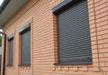 Rolling shutters house windows protection. Brick house with roller shutters on the windows Royalty Free Stock Photo