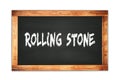 ROLLING STONE text written on wooden frame school blackboard