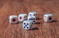 Rolling three dice on a wooden desk Royalty Free Stock Photo