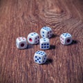 Rolling three dice on a wooden desk Royalty Free Stock Photo