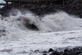 Rolling wave on stone coastline at storm