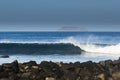 Rolling waves, island and rocks Royalty Free Stock Photo