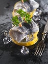 Rollmop herring on lemon slices and ice cubes Royalty Free Stock Photo