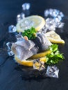 Rollmop herring on lemon slices and ice cubes Royalty Free Stock Photo
