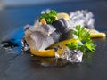 Rollmop herring on lemon slices and ice cubes Royalty Free Stock Photo