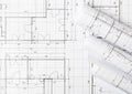 Rolls of architectural blueprint house building plans on blueprint background flat lay