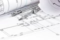 Rolls of architecture blueprint with drawing compass closeup Royalty Free Stock Photo