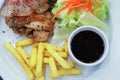 Rolls of bacon and chicken steak with French fries and red sauce and salads