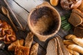 Rolls and breads on wooden table with wooden bowl, background for bakery or market Royalty Free Stock Photo