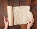 Rolls of brown parchment paper on a wooden surface Royalty Free Stock Photo