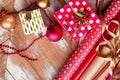 Rolls of Christmas wrapping paper with ribbons, gifts and bolls Royalty Free Stock Photo