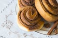 Rolls Cinnabon with cinnamon and sugar on embroidered tablecloth Royalty Free Stock Photo