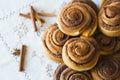 Rolls Cinnabon with cinnamon and sugar on embroidered tablecloth Royalty Free Stock Photo