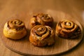 Rolls Cinnabon cinnamon and sugar, on a wood round plate Royalty Free Stock Photo