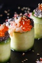 Rolls covered in cucumber with caviar and prawn