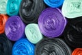 Rolls of different color garbage bags as background, closeup Royalty Free Stock Photo