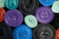 Rolls of different color garbage bags as background, top view Royalty Free Stock Photo