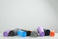 Rolls of different color garbage bags on table against light background. Space for text Royalty Free Stock Photo