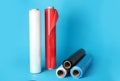 Rolls of different plastic stretch wrap on light blue background. Space for text Royalty Free Stock Photo