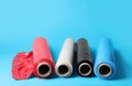 Rolls of different plastic stretch wrap on light blue background. Space for text Royalty Free Stock Photo