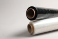 Rolls of different stretch wrap on light grey background, closeup. Space for text Royalty Free Stock Photo