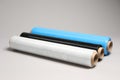 Rolls of different stretch wrap on light grey background Royalty Free Stock Photo