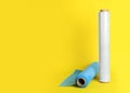 Rolls of different stretch wrap on yellow background. Space for text Royalty Free Stock Photo