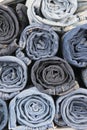 Rolls of different worn blue jeans stacked Royalty Free Stock Photo