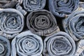 Rolls of different worn blue jeans stacked Royalty Free Stock Photo