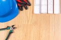 Rolls of electrical drawings, protective helmet with gloves and work tools, accessories for engineer jobs