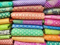 Rolls of fabric and textiles in shop. Multi colors indian patterns on the market Fabrics in rolls. Fabric store in Pune,