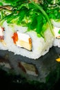 Rolls with fish, cheese and green algae. A traditional Japanese dish. Close up Royalty Free Stock Photo