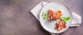 Rolls of fried bacon and mashed potatoes and basil on a plate on the table. Top view. Web banner Royalty Free Stock Photo