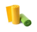 Rolls of green and yellow garbage bags on white background Royalty Free Stock Photo