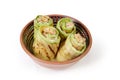 Rolls of grilled vegetable marrow with filling in bowl Royalty Free Stock Photo