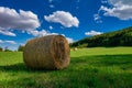 Rolls haystacks straw on field, harvesting wheat. Rural field with bales of hay.