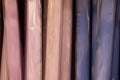 Rolls of iridescent curtains in beige and blue
