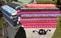 Rolls of multicolored fabric and textiles at market on sale, different patterns Royalty Free Stock Photo