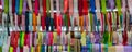 Rolls of multicolored silk ribbons in a shop window.