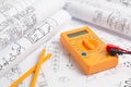 Electrical engineering drawings, pencil and digital multimeter Royalty Free Stock Photo