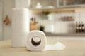 Rolls of paper towels on table in kitchen. Royalty Free Stock Photo