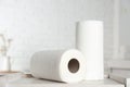 Rolls of paper towels on white table in kitchen Royalty Free Stock Photo