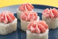 Rolls with pink Lava sauce on a dark blue plate