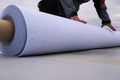 Rolls of polymer coating for roof. Deployment of a roof covering roll Royalty Free Stock Photo