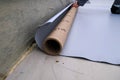 Rolls of polymer coating for roof. Deployment of a roof covering roll Royalty Free Stock Photo