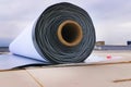 Rolls of polymer coating for roof. Deployment of a roof covering roll Royalty Free Stock Photo