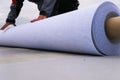 Rolls of polymer coating for roof. Deployment of a roof covering roll Royalty Free Stock Photo